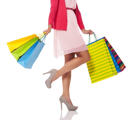 Woman holding colorful shopping bagsの写真素材