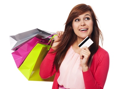 Dreaming woman with shopping bags and credit card の写真素材