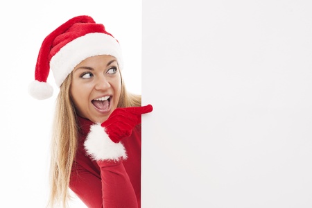 Christmas woman pointing at copyspaceの写真素材
