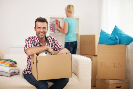 Young couple unpacking in their new home の写真素材
