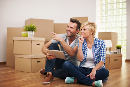 Happy couple thinking about decoration in new home の写真素材