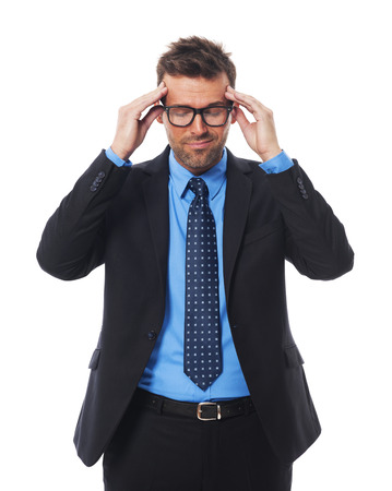 Businessman wearing glasses with awful headache の写真素材