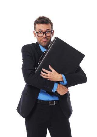 Frightened man firmly clutching his briefcaseの写真素材