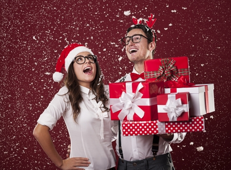 Happy nerd couple with christmas presentsの写真素材