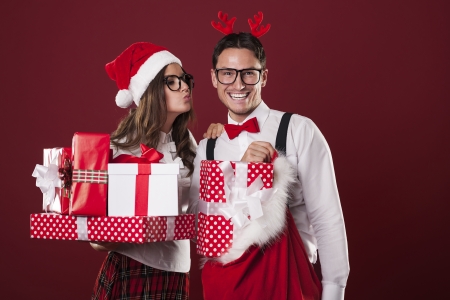 Loving couple with a lot of christmas gifts の写真素材