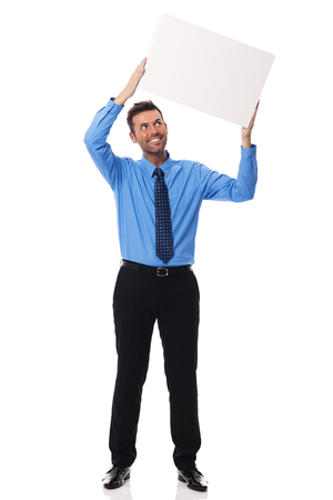 Smiling businessman holding blank placardの写真素材