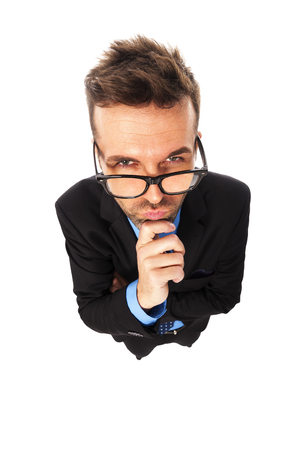 Angry businessman wearing fashion glasses grimacing の写真素材