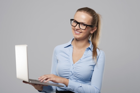 Beautiful young businesswoman using laptop の写真素材