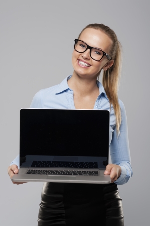 Smiling businesswoman showing screen of laptopの写真素材