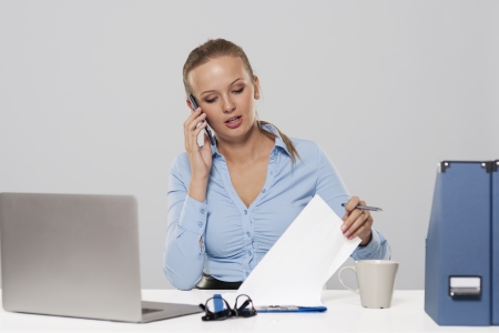 Portrait of busy young businesswoman の写真素材