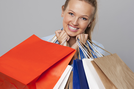 Smiling woman with a lot of shopping bags の写真素材
