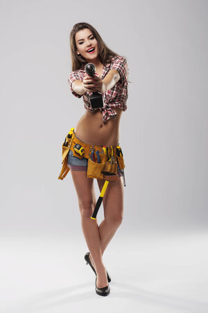 Female construction worker have fun with drillの写真素材