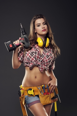 Passionate female construction worker is ready for drilling の写真素材