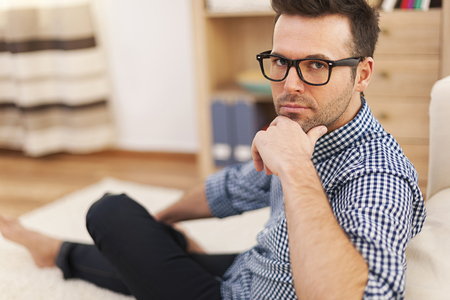 Portrait of serious man in domestic room の写真素材