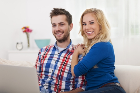 Portrait of smiling couple with contemporary laptop の写真素材