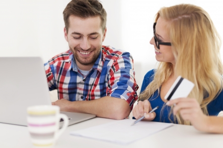 Couple paying bills by credit card の写真素材