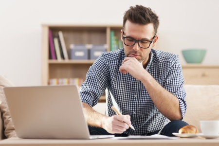 Portrait of focus man working at home の写真素材