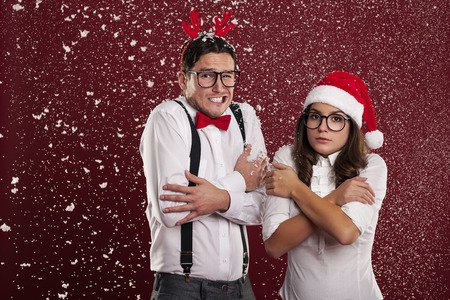 Funny couple shaking from cold weather in christmas time の写真素材