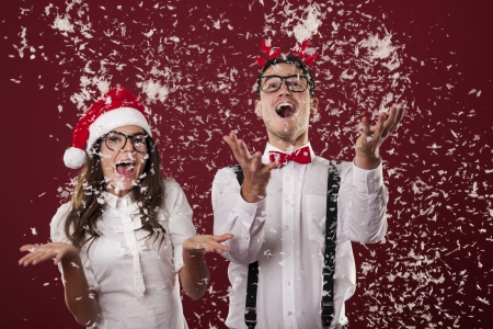 Happy couple are excited from christmas snow の写真素材
