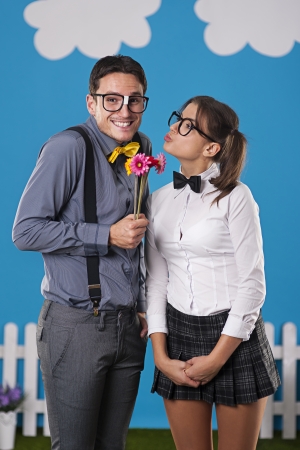 Nerdy man giving his girlfriend couple flowers 
の写真素材