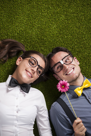 Loving couple lying down on the grassの写真素材