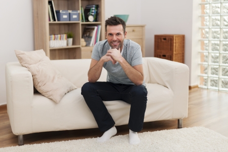 Portrait of handsome man in living room の写真素材
