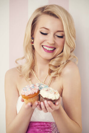 Happy elegant woman with muffins の写真素材