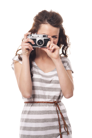 Brunette young woman taking photo by retro camera
の写真素材