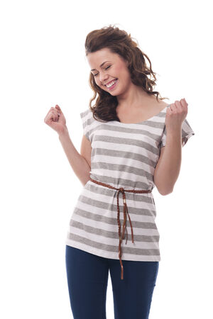 Portrait of brunette woman celebrating success の写真素材