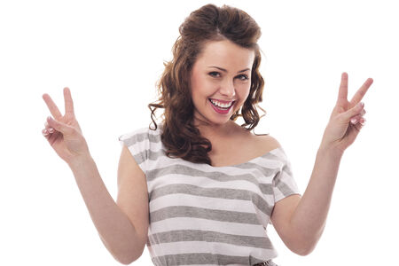 Brunette woman gesturing peace sign の写真素材