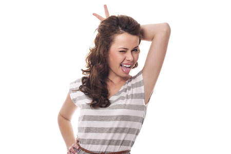 Funny woman with horns sticking out tongueの写真素材