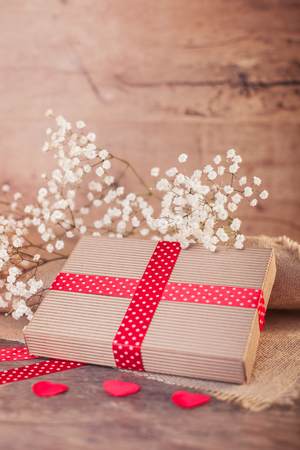 Valentine's gift with red ribbon on wood の写真素材