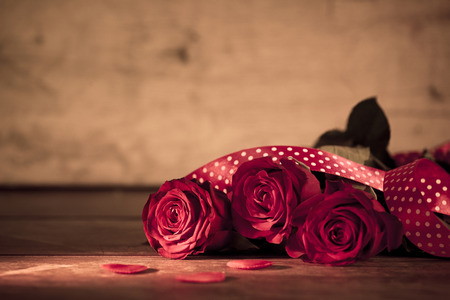 Valentine's day red roses on wood の写真素材