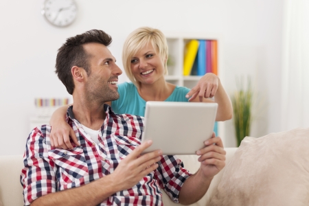 Blonde beautiful woman showing something on digital tabletの写真素材