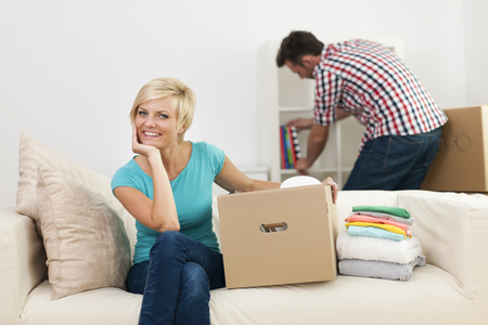 Portrait of smiling woman during the decorating new living roomの写真素材