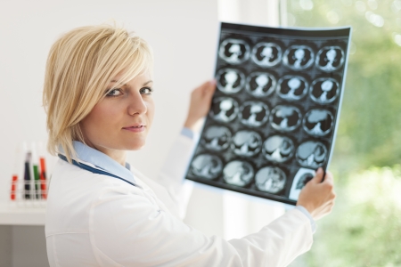 Blonde female doctor holding x-ray imageの写真素材