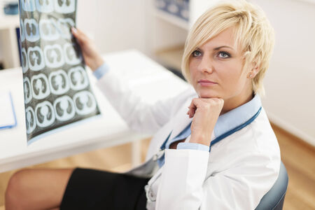 Pensive female doctor with x-ray imageの写真素材