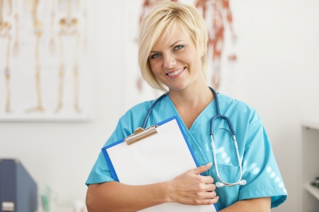 Portrait of smiling blonde female surgeonの写真素材