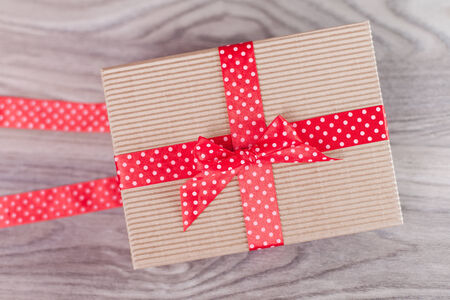 Wrapped gift box on woodの写真素材