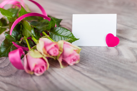 Valentine card with roses on wood の写真素材