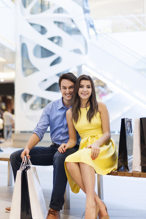 Portrait of smiling couple in shopping mall の写真素材