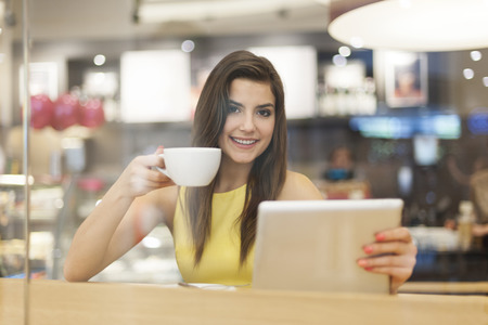 Portrait of beautiful woman in cafe with digital tablet の写真素材