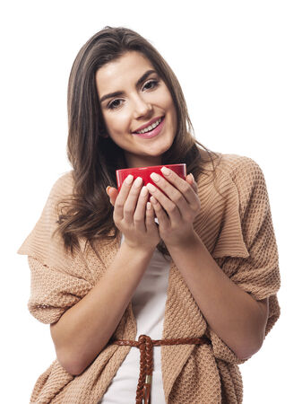 Friendly woman with red cup of coffeeの写真素材