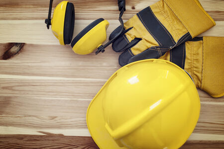 Protective wear for construction worker on wooden plank 