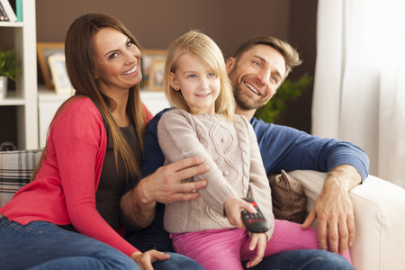 Happy family watching tv at home 
の写真素材