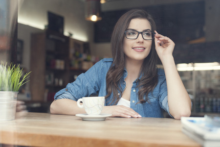 Portrait of beautiful woman at cafe の写真素材