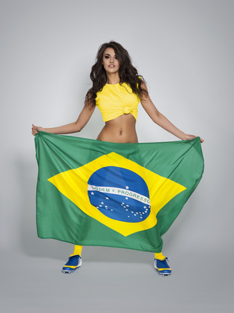 Passionate woman cheering of brazilian team の写真素材