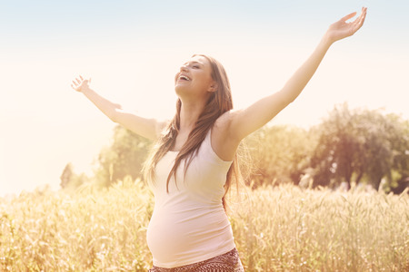 Pregnant woman enjoying the natureの写真素材