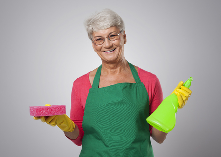 Senior woman with cleaning detergentの写真素材