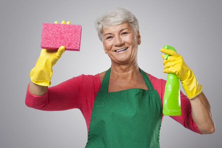 Senior woman with cleaning detergentの写真素材